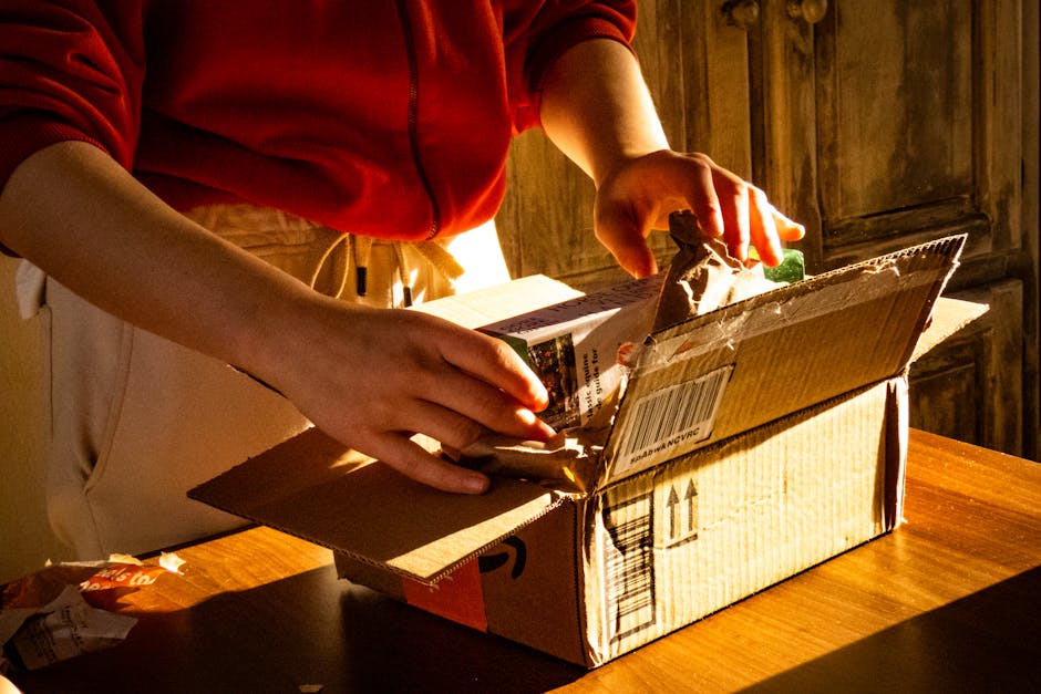 A person unboxing a package, revealing curiosity and anticipation in a warmly lit setting.